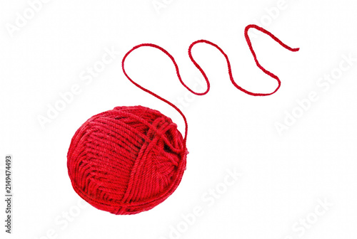 Fotografie Single red wool yarn ball with wavy loose strand