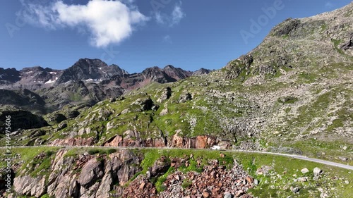 Aerial view of a vehicle driving through the mountain landscape of the Alps of Austria on Kaunertal Gletscherstraße