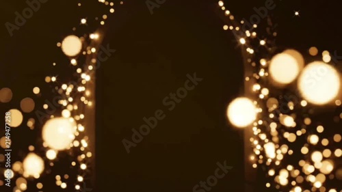 Magical bokeh lights archway forming abstract shimmering portal effect with golden particles, celebrating festive and fantasy moments.