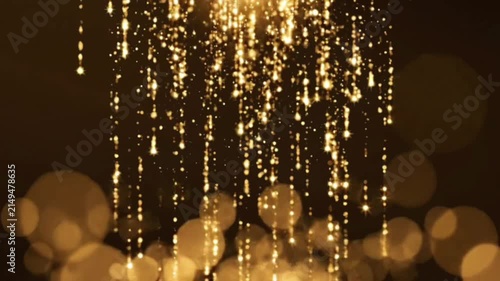 Golden glitter particles falling from top with bokeh light background and shimmering effects create luxury motion design for festive celebrations or awards.
