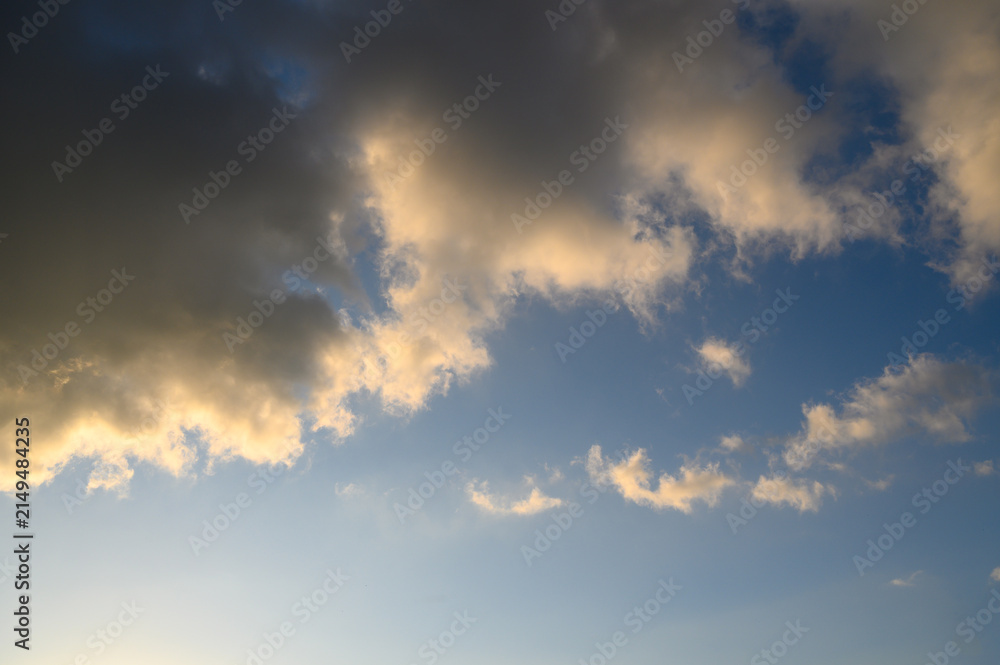 Fototapeta premium Cloudscape with colorful clouds during sunrise or sunset golden light illuminating edges of dark 