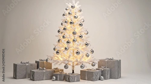 Christmas tree with shimmering silver ornaments and warm white lights surrounded by beautifully wrapped gifts, sparkling holiday cheer and festive celebration.