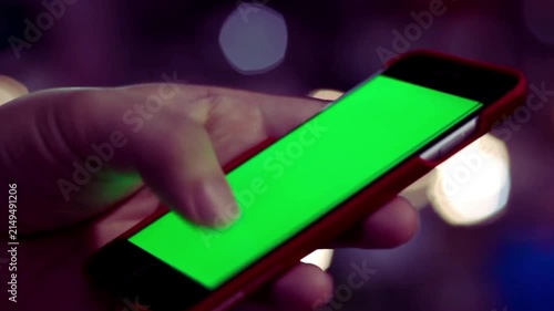 Close Up of Hand Holding Smartphone with Green Screen Mockup