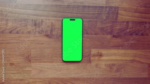 Top View of Smartphone with Green Screen on Wooden Table