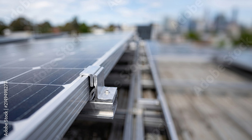 Close-up of aluminum mounting clamp securing rooftop solar panel