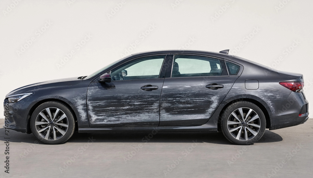 Naklejka premium Scratched grey sedan car body side door damage after collision waiting for insurance repair and paint restoration