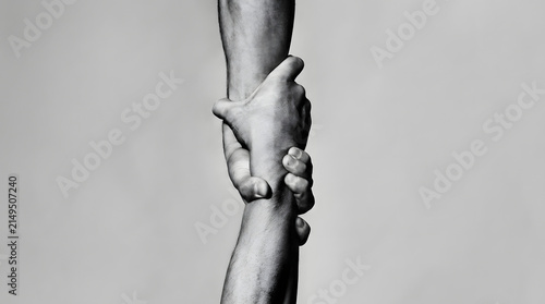Two Human Hands Grasping Each Other Firmly to Represent Trust Support and Helping Someone in Need During Difficult Moments of Life