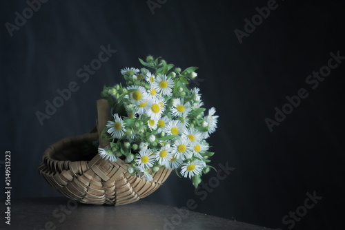 Field flowers in a woven wicker basket
