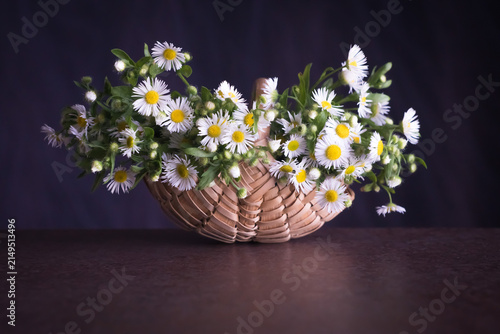 Field flowers in a woven wicker basket
