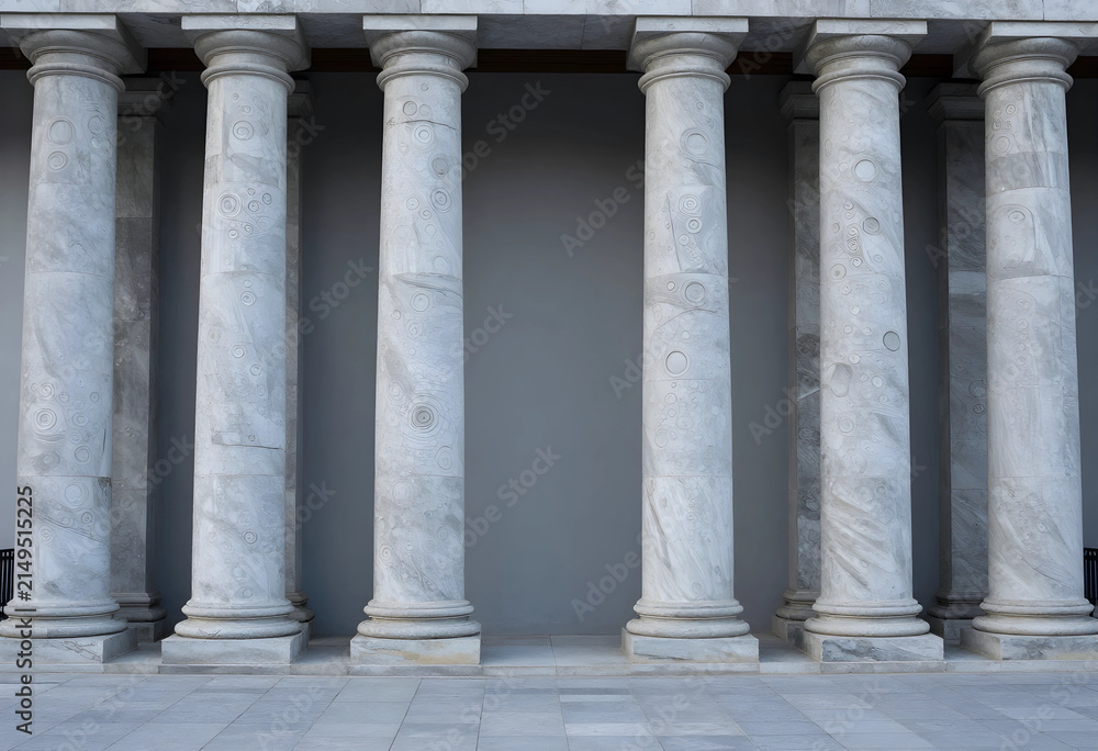 Fototapeta premium Row of classical marble columns with intricate circular patterns and a gray wall background, the architectural details suggest a historical or institutional building, providing a sense