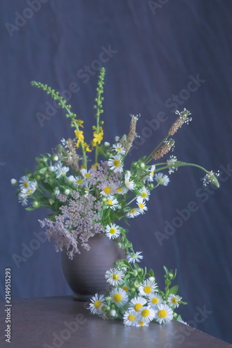 Background with field flowers in a vase