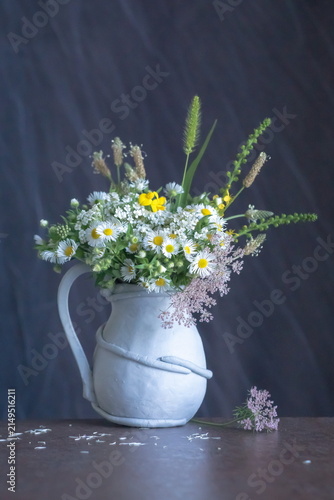 Background with field flowers in a vase