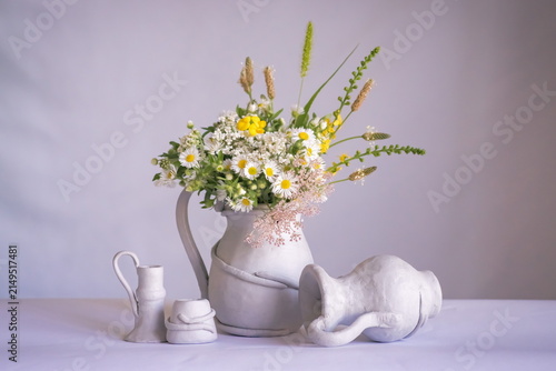 Background with field flowers in a vase