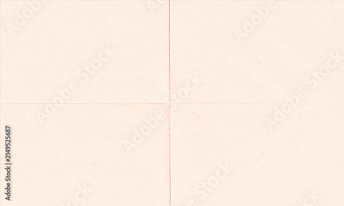 Фотография A light peach colored paper texture with a distinct cross fold pattern dividing