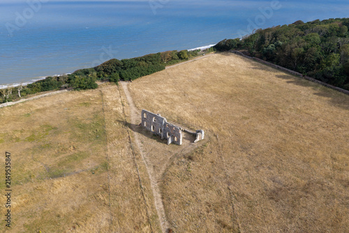 Canvas Print Stone Ruins Stand in a Dry Grassy Field Near the North Sea Coast at Dunwich in E