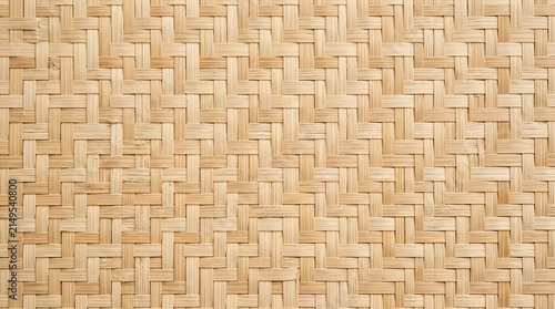 Close up view of a hand woven bamboo mat texture showing intricate patterns and natural light brown colors