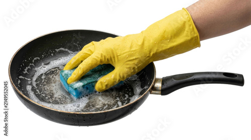 Foto Hand in yellow glove cleaning frying pan with sponge and soap bubbles