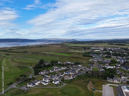 Dornoch is a historic Highland town in northern Scotland, seen from above with homes, streets, green landscapes, 1224 cathedral, and 1509 castle.