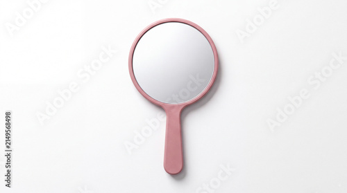 Handheld Mirror: A simple, pink handheld mirror with a circular reflective surface rests on a neutral backdrop, ready for use.