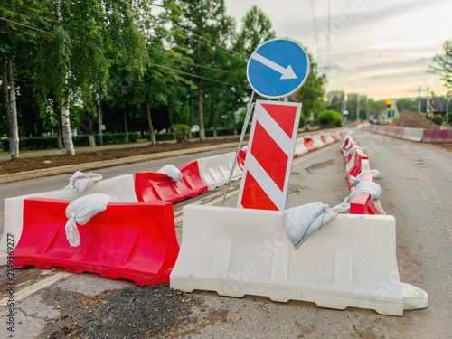 Traffic barricades with directional arrow on street