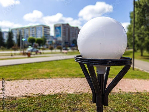 Quadro su tela Streetlamp in urban park during a sunny day