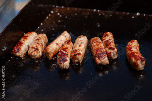 Cooking Breakfast Sausages 2. Sausages cooked for breakfast on an outdoor grill while camping.