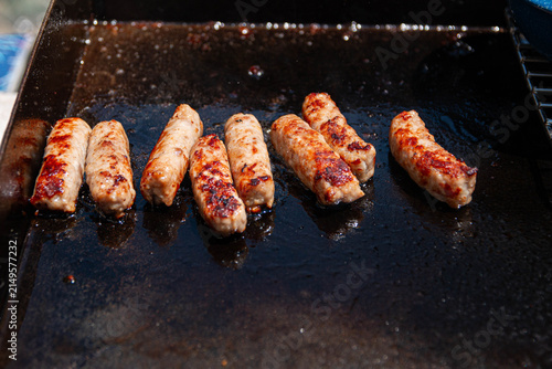 Cooking Breakfast Sausages 1. Sausages cooked for breakfast on an outdoor grill while camping.