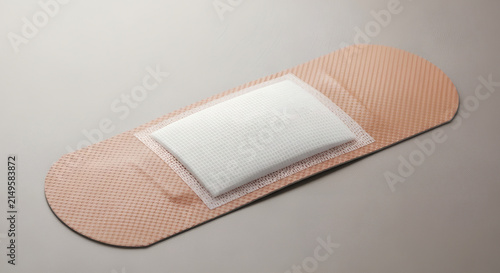 Single adhesive bandage plaster medical strip close up on neutral background