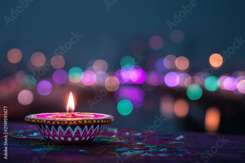 Colorful Diya Oil Lamp with Glowing Flame and Festive Bokeh Lights for Diwali, ai generated