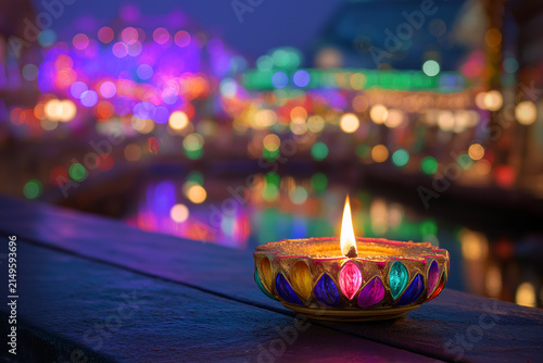 Colorful Diya Oil Lamp with Glowing Flame and Festive Bokeh Lights for Diwali, ai generated