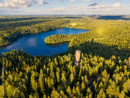 Scenic aerial landscape with a seek tower from Finland Aulanko with dense forest and lake background