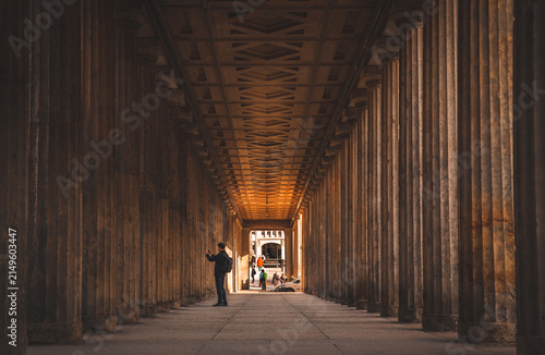 Fotografía Berlin, Germany - A visitor photographs an illuminated neoclassical colonnade in the city's historic museum district