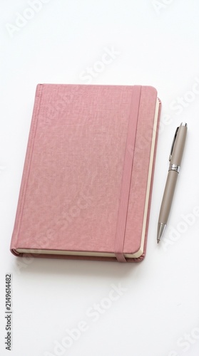 Pink notebook and pen symbolizing breast cancer awareness, support, and education for women's health