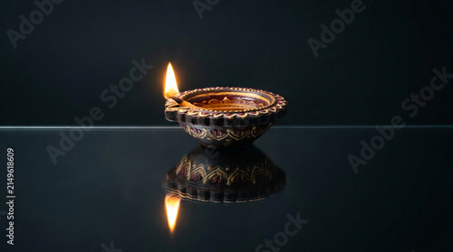 A single diya flame illuminates the spirit of diwali the festival of lights