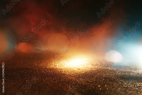 Fiery, luminous mist glows over a glittery, textured surface