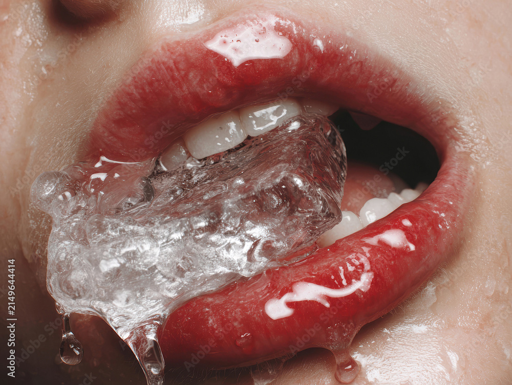 Fototapeta premium Close-up macro shot of a persons red lips, holding a melting ice cube Shiny, textured ice with air bubbles and condensation Hyper-detailed skin texture, pores, teeth shape, lip asymm - AI-Generated