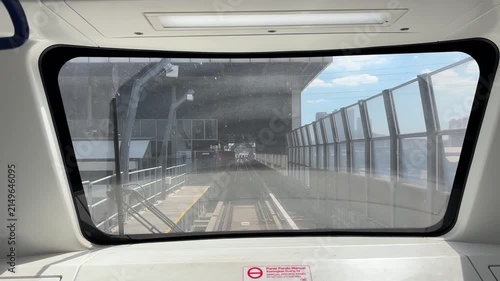First person point of view of a light rail train driving on elevated tracks in the city.
