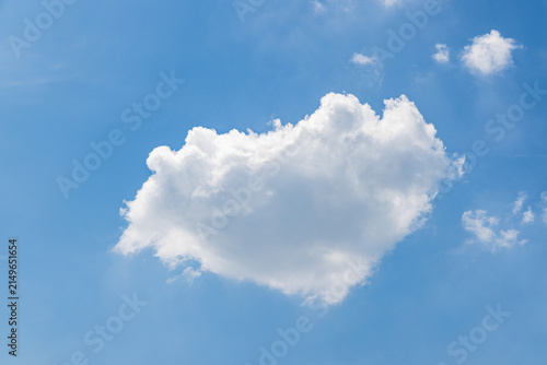 Photography Bright blue sky with a large fluffy white cumulus cloud and small scattered clouds, clear and serene daytime scene