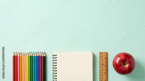Rainbow Pencils Notebook Teal Background — School Supply Flat-Lay