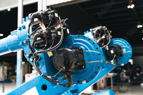 Картината върху платно Blue robotic arm industrial machinery factory, automated robotic arm with cable