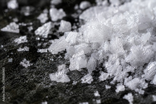 Macro shot of sea salt crystals on dark stone background