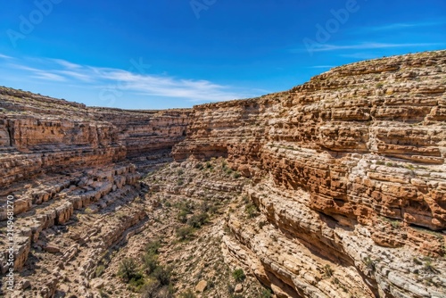 Deep desert canyon gorge landscape with layered rock cliffs