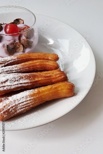 Churros, crispy and golden, dusted with sugar and cinnamon. A delicious, sweet treat often enjoyed with chocolate dipping sauce, perfect for satisfying any dessert craving.