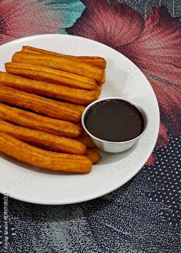 Churros, crispy and golden, dusted with sugar and cinnamon. A delicious, sweet treat often enjoyed with chocolate dipping sauce, perfect for satisfying any dessert craving.