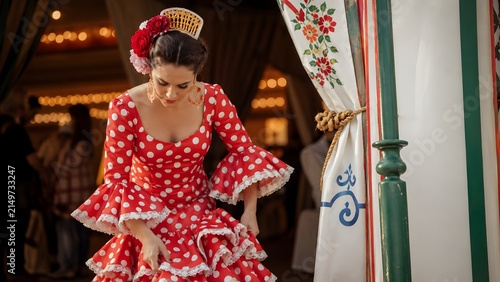 Elegant woman in red polka dot flamenco dress at the Seville April Fair