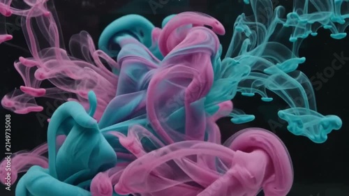 Abstract Ink Diffusion: Vibrant streams of pink and blue ink swirl and diffuse in water, creating an ethereal and dynamic abstract visual.