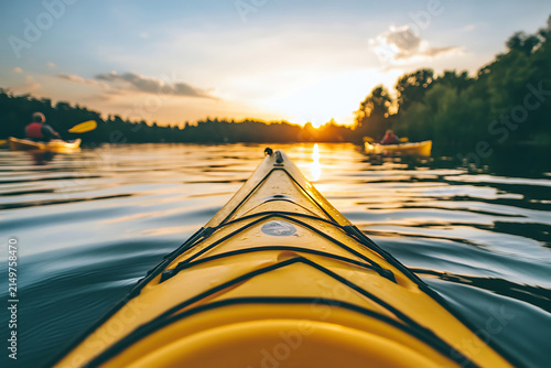 People kayaking on a serene lake at sunset representing outdoor adventure relaxation and tranquility.
