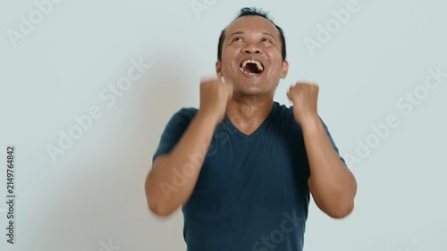 Happy confident Asian man winner celebrating success showing hands gesture yes, 4K video footage.