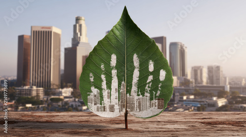 Green leaf showing cityscape and eco friendly clean energy handprint