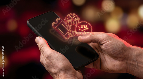Digital cinema ticket on smartphone screen, mobile movie booking app with popcorn icon, online theater reservation concept